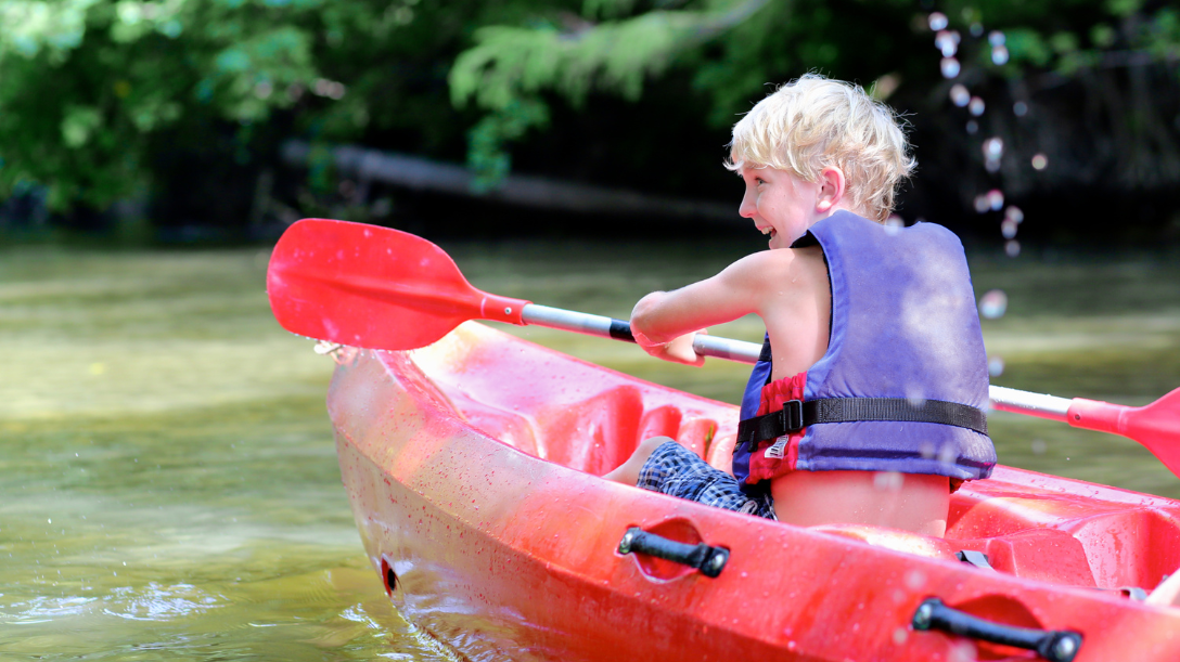 Child canoeing in a lake