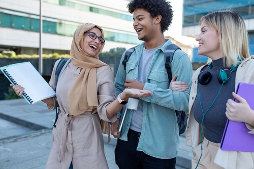 Group of diverse students after school smiling together and walking