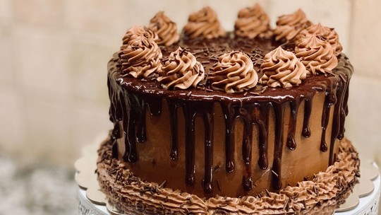 A large, heavily iced and decorated chocolate cake