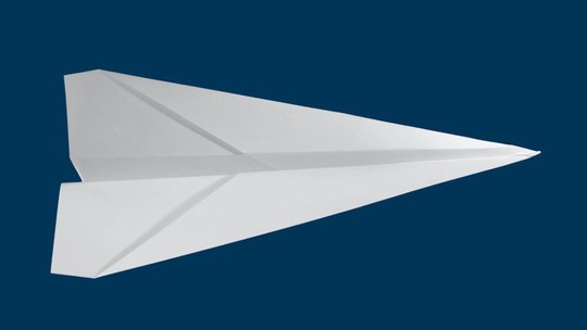 A white paper plane on a dark blue background