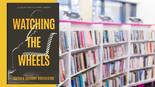 An out of focus image of bright library bookshelves overlaid with the cover for Watching the Wheels by Stephen Brotherton