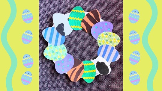 An Easter wreath made from cut-out card eggs, coloured in and decorated