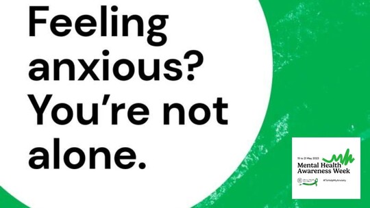 Big text 'Feeling anxious? You're not alone?' on a green background. Small text 'Mental Health Awareness Week' in bottom right corner