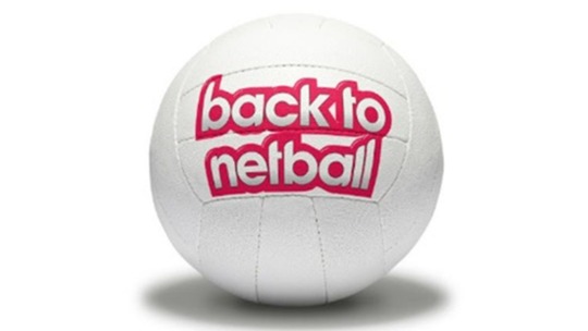 A large white netball with the words 'Back to Netball' written on it in big red and white letters 