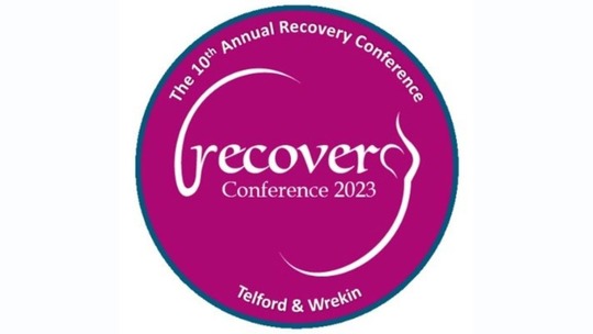 The Recovery Conference 2023 logo, in which the word 'recovery' appears in white text in a pink-purple circle