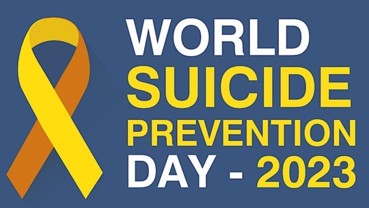 White and yellow text on blue background reads 'World Suicide Prevention Day 2023'. A yellow ribbon appears left of the text.