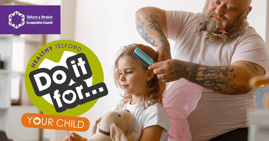 A large, tattooed man brushes his young daughter's hair. Some of her hair clips are in his beard. Text reads: Do it for ... your child. 