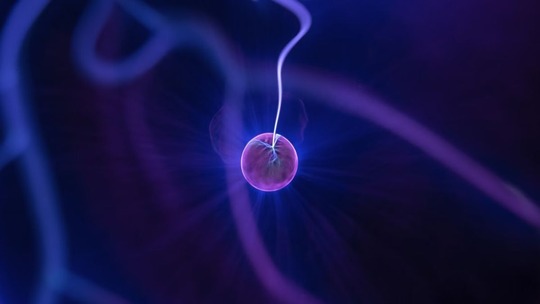 A small pink ball crackling with electricity (the centre of a Van de Graaff generator)