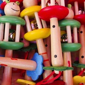 Lots of children's wooden noise makers, painted in reds, blues, greens and yellows.