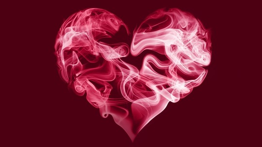 A heart made of pinkish red smoke, on a very dark red background