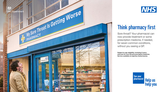 A man looking up at his Pharmacy's sign above the door, which reads: My sore throat is getting worse. Pharmacy.
