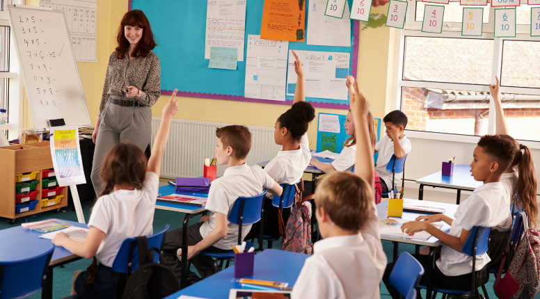 primary school classroom teacher and pupils