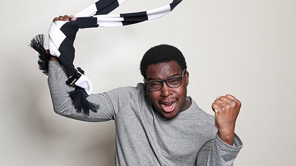 A football fan waving a scarf