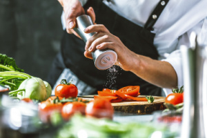 Person chopping tomatoes