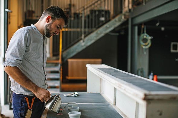 Person making a coffee in a workshop