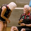 A man and a woman aged over 60 in a sports hall