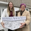 Mollie being presented with her baby bundle by Dawn Bowden