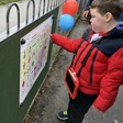 Bash playing with a communication board at Pentre Mawr Park in Abergele