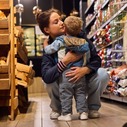 Parent hugging a child in the supermarket