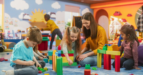 Children and an adult in a childcare setting