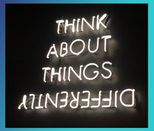 Neon text: Think about things differently. The word differently is upside down.