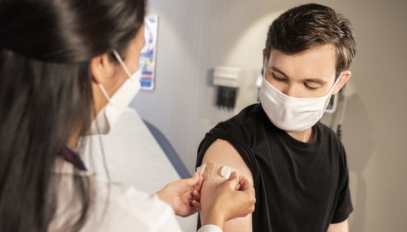 A child gets a plaster after their vaccination