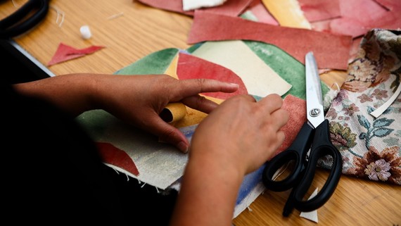 Close up on hands working with scraps of material