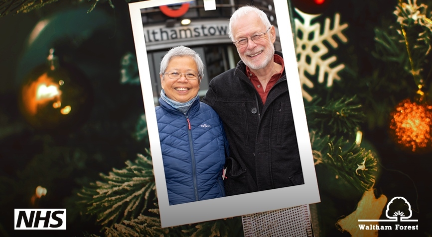An older couple post in a picture frame in front of the Walthamstow bus station sign on a festive background