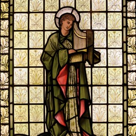 Figure of St. Cecilia in stained glass.