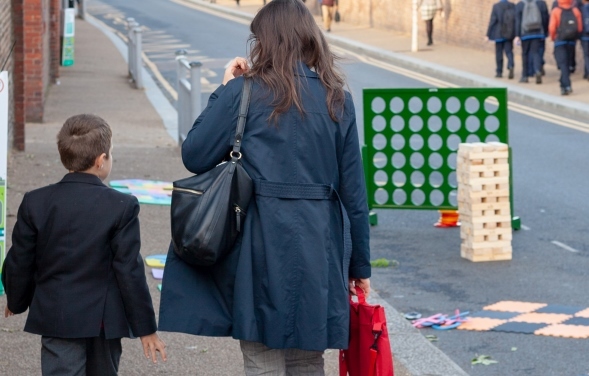 A mother walks her son to school
