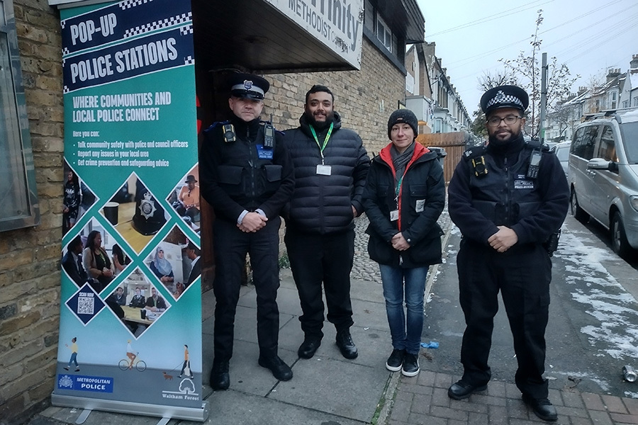 Police and Council officers stand outside a pop-up police station