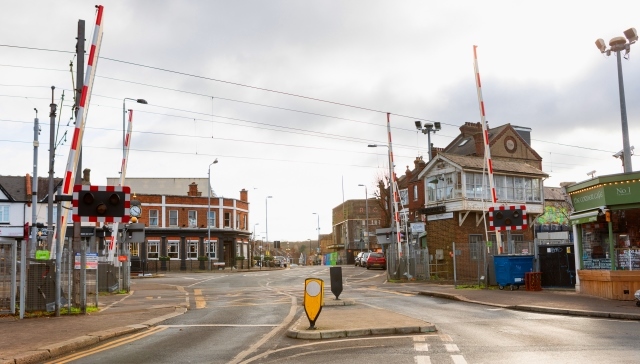 HIghams Park town centre looking through the level crossing to the village side