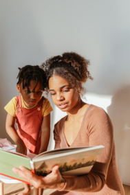 Woman and child reading a book together