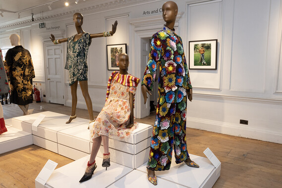 Three mannequins, the oneat the front in a brightly crocket trouser suit, upstairs at William Morris Gallery