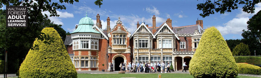 A large group walks outside Bletchley Park, a grand old house sitting in landscaped grounds