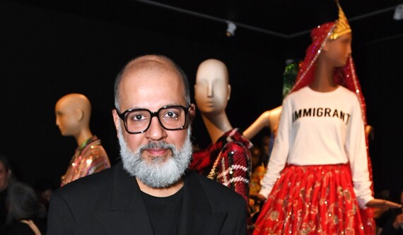 Ashish standing in front of one of his designs at William Morris Gallery