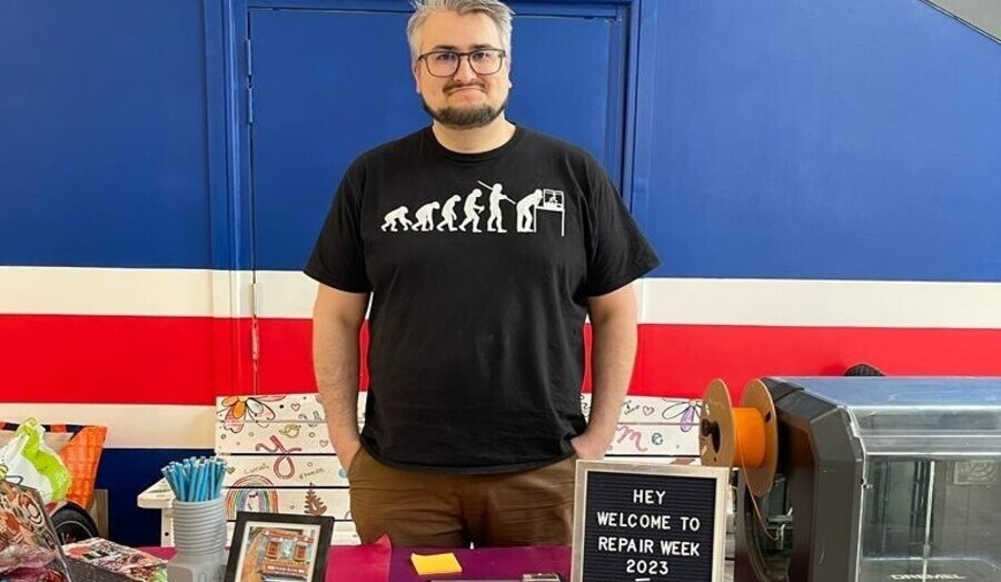 Sean Roderigo stands behind a stall at Repair Week 2023