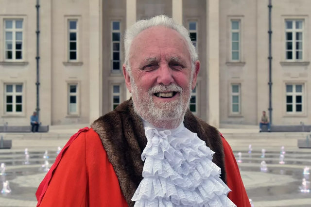 Cllr Roy Berg wearing his mayoral chain of office outside Waltham Forest Town Hall