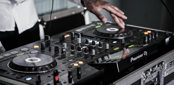 Close up of a pair of hands working a sound system