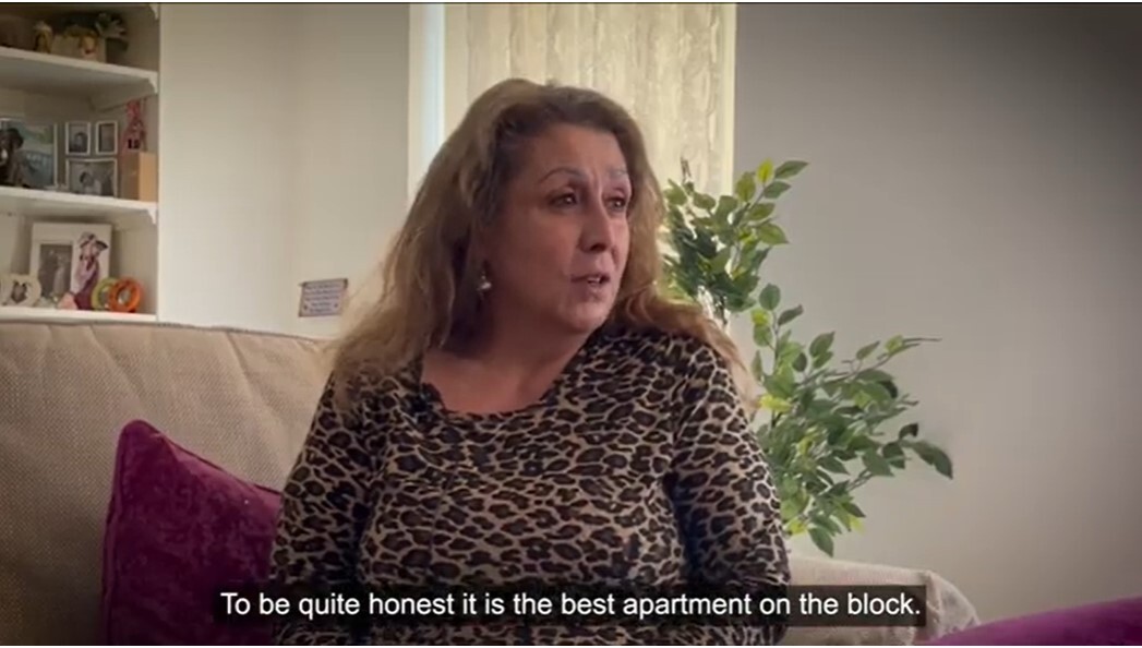 A woman sits talking with a caption: 'To be honest, it's the best apartment on the block'