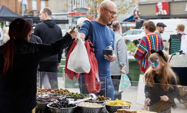 A man and child shop at a stall at Chingford Mount