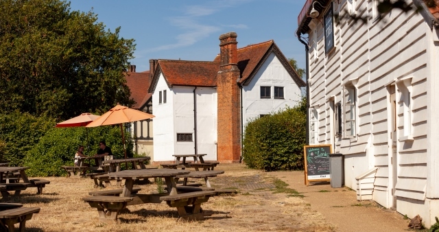 The Queen Elizabeth Hunting Lodge with Butlers Retreat to the foreground