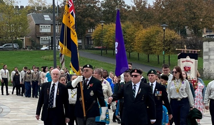 A group of people parade in Fellowship Square before the 2022 Remembrance Service