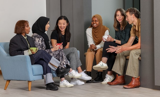 A group of young people sit chatting