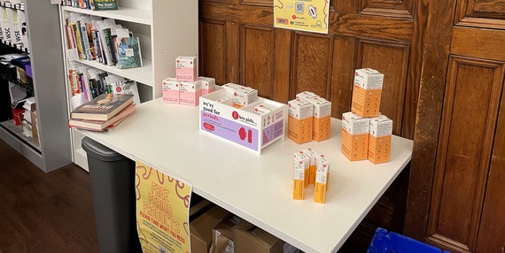 Boxes of period products on a table in a library