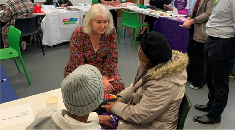Cllr Louise Mitchell chats to two women in a room