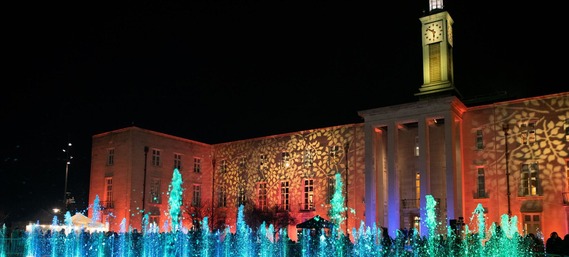 Town Hall illuminated with brightly coloured fountains