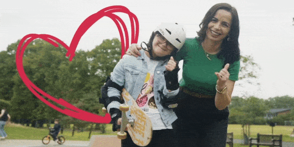 Gif of a smiling foster child and carers giving a thumbs up. The child is holding a skateboard