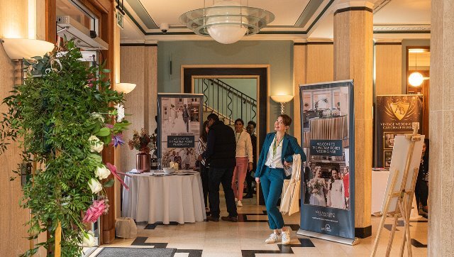 Photo by @alexandriaphotography . An exhibitor poses and smiles at the camera at a wedding fair in Waltham Forest Town Hall.