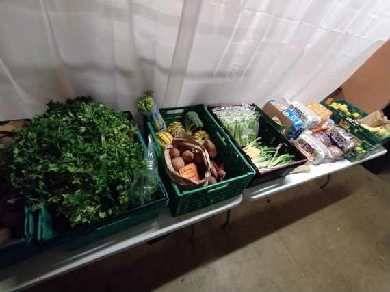 Crates of fruits and vegetables against a wall